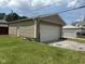 View of a detached one-car garage with light-colored siding and a white garage door at 1902 Westview Dr, Indianapolis, IN 46221