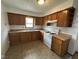 Functional kitchen with wood cabinets, updated countertops, and essential appliances at 1902 Westview Dr, Indianapolis, IN 46221