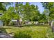 This large backyard features a tall shade tree and a wooden fence at 1927 N Cherry St, Columbus, IN 47201