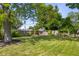 A beautifully manicured backyard offers plenty of green space with a wood fence around the perimeter at 1927 N Cherry St, Columbus, IN 47201