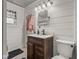 Cozy bathroom featuring a vanity with drawers, a white sink, and shiplap walls at 1927 N Cherry St, Columbus, IN 47201