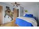 Bedroom featuring hardwood floors, a ceiling fan and dinosaur themed decor at 1927 N Cherry St, Columbus, IN 47201