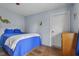 This bedroom has pale blue walls and a full size bed covered with blue and white bedding at 1927 N Cherry St, Columbus, IN 47201
