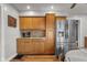 Eat-in kitchen with stainless steel refrigerator and wood cabinetry and adjacent breakfast area at 1927 N Cherry St, Columbus, IN 47201