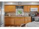 Efficient kitchen design with wooden cabinets, modern appliances, and a garden view at 1927 N Cherry St, Columbus, IN 47201