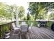 Outdoor dining set and grill on a spacious back deck surrounded by trees and greenery at 218 Narcissus Dr, Indianapolis, IN 46227