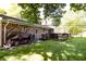Backyard featuring a brick home, deck, and grassy area at 218 Narcissus Dr, Indianapolis, IN 46227