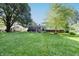 Extensive grassy backyard with mature trees and shrubs offering a peaceful retreat at 218 Narcissus Dr, Indianapolis, IN 46227
