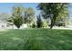 Large grassy backyard surrounded by mature trees and shed at 218 Narcissus Dr, Indianapolis, IN 46227