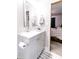 Bathroom featuring white vanity with gray cabinets, and view to bedroom with wooden bed frame at 218 Narcissus Dr, Indianapolis, IN 46227