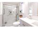 Elegant white bathroom with glass enclosed shower, toilet, and vanity with storage at 218 Narcissus Dr, Indianapolis, IN 46227