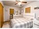 Bedroom featuring queen-size bed with white frame, dresser with mirror, ceiling fan, and brown blinds at 218 Narcissus Dr, Indianapolis, IN 46227
