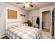 Bedroom with queen-size bed, ceiling fan with lights, bedside table and closet in background at 218 Narcissus Dr, Indianapolis, IN 46227
