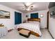 Bedroom with a large bed, ceiling fan, blue curtains and a chest at 218 Narcissus Dr, Indianapolis, IN 46227