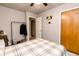 Bedroom with queen-size bed, ceiling fan with lights, wooden closet, and view to the hallway at 218 Narcissus Dr, Indianapolis, IN 46227