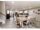 Open-concept dining room with table for eight guests and modern, gray plank flooring at 218 Narcissus Dr, Indianapolis, IN 46227