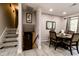 Dining room with wood table and seating for four, next to a stairway leading to the basement at 218 Narcissus Dr, Indianapolis, IN 46227