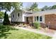 Home featuring a brick facade, siding, charming landscape, and walkway at 218 Narcissus Dr, Indianapolis, IN 46227