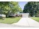 Charming home with brick facade, siding, driveway, well-maintained lawn, and mature trees at 218 Narcissus Dr, Indianapolis, IN 46227
