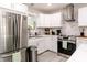 Bright kitchen featuring white cabinets, stainless steel appliances, and marble backsplash, perfect for cooking and entertaining at 218 Narcissus Dr, Indianapolis, IN 46227