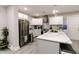 Kitchen with white cabinetry, island, stainless steel appliances, and marble countertops at 218 Narcissus Dr, Indianapolis, IN 46227