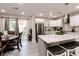 Open-concept kitchen with stainless steel appliances, an island with seating, and a door to the backyard at 218 Narcissus Dr, Indianapolis, IN 46227