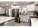 Modern kitchen with stainless steel refrigerator, sleek countertops, and ample storage, creating a functional space at 218 Narcissus Dr, Indianapolis, IN 46227