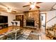 Inviting living room featuring a brick fireplace, hardwood floors, and a bar area, perfect for relaxing at 218 Narcissus Dr, Indianapolis, IN 46227