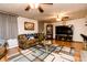 Cozy living room featuring a comfortable sofa, entertainment center, and a ceiling fan for added comfort at 218 Narcissus Dr, Indianapolis, IN 46227