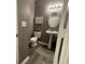 Powder room featuring a toilet, pedestal sink, light fixture, and framed artwork at 2485 Blue Ridge Dr, Greenwood, IN 46143