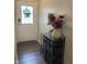 Welcoming entryway featuring a decorative table with flowers and storage baskets, next to a white front door at 2485 Blue Ridge Dr, Greenwood, IN 46143