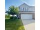 Well-manicured two-story home featuring a two-car garage, established tree and green lawn at 2485 Blue Ridge Dr, Greenwood, IN 46143