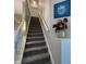Carpeted staircase with white banister and wall art, leading to the upper level at 2485 Blue Ridge Dr, Greenwood, IN 46143