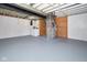 Spacious basement with painted floors and exposed ceiling, laundry, and utility equipment at 2606 Shakespeare Dr, Southport, IN 46227