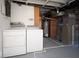 A finished basement featuring a laundry area and utilities for functionality at 2606 Shakespeare Dr, Southport, IN 46227