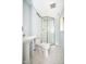 Bathroom with a walk-in shower, toilet, and sink on a pedestal with marble floors at 2606 Shakespeare Dr, Southport, IN 46227