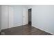 A bedroom with light blue walls, wood floors, and closet at 2606 Shakespeare Dr, Southport, IN 46227