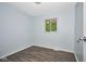 Empty bedroom with hardwood floors and a window for natural light at 2606 Shakespeare Dr, Southport, IN 46227