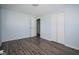 A bedroom with light blue walls, wood floors, and a closet at 2606 Shakespeare Dr, Southport, IN 46227