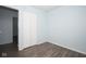 This bedroom features wood floors, a white closet, and blue painted walls at 2606 Shakespeare Dr, Southport, IN 46227