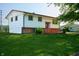 Split-level home with white siding, orange trim, brick accents and a small front porch at 2606 Shakespeare Dr, Southport, IN 46227