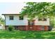 Split-level home with white siding, orange trim and a small front porch with a 'For Sale' sign at 2606 Shakespeare Dr, Southport, IN 46227