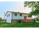 Split-level home with white siding, orange trim, brick accents and a small front porch at 2606 Shakespeare Dr, Southport, IN 46227