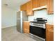 Stainless steel refrigerator and oven with wooden cabinets in a modern kitchen at 2606 Shakespeare Dr, Southport, IN 46227
