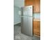 Stainless steel refrigerator with wooden cabinets and vinyl floors at 2606 Shakespeare Dr, Southport, IN 46227
