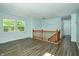 A spacious living room featuring light blue walls, wood floors, and natural light from the windows at 2606 Shakespeare Dr, Southport, IN 46227