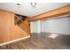 Open living room with wood paneling and staircase at 2606 Shakespeare Dr, Southport, IN 46227