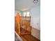 Wooden staircase featuring wooden railing and neutral colored floor in the home at 2606 Shakespeare Dr, Southport, IN 46227