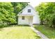 The backyard has a well-maintained lawn, surrounded by lush trees, offering a private outdoor space at 2650 S Meridian St, Indianapolis, IN 46225