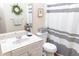 Full bathroom with vanity, decorative mirror, and striped shower curtain at 2650 S Meridian St, Indianapolis, IN 46225